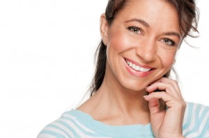 Middle aged woman pleased with her teeth whitening treatment