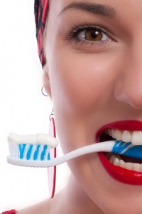 Woman with Red Lips Biting Toothbrush